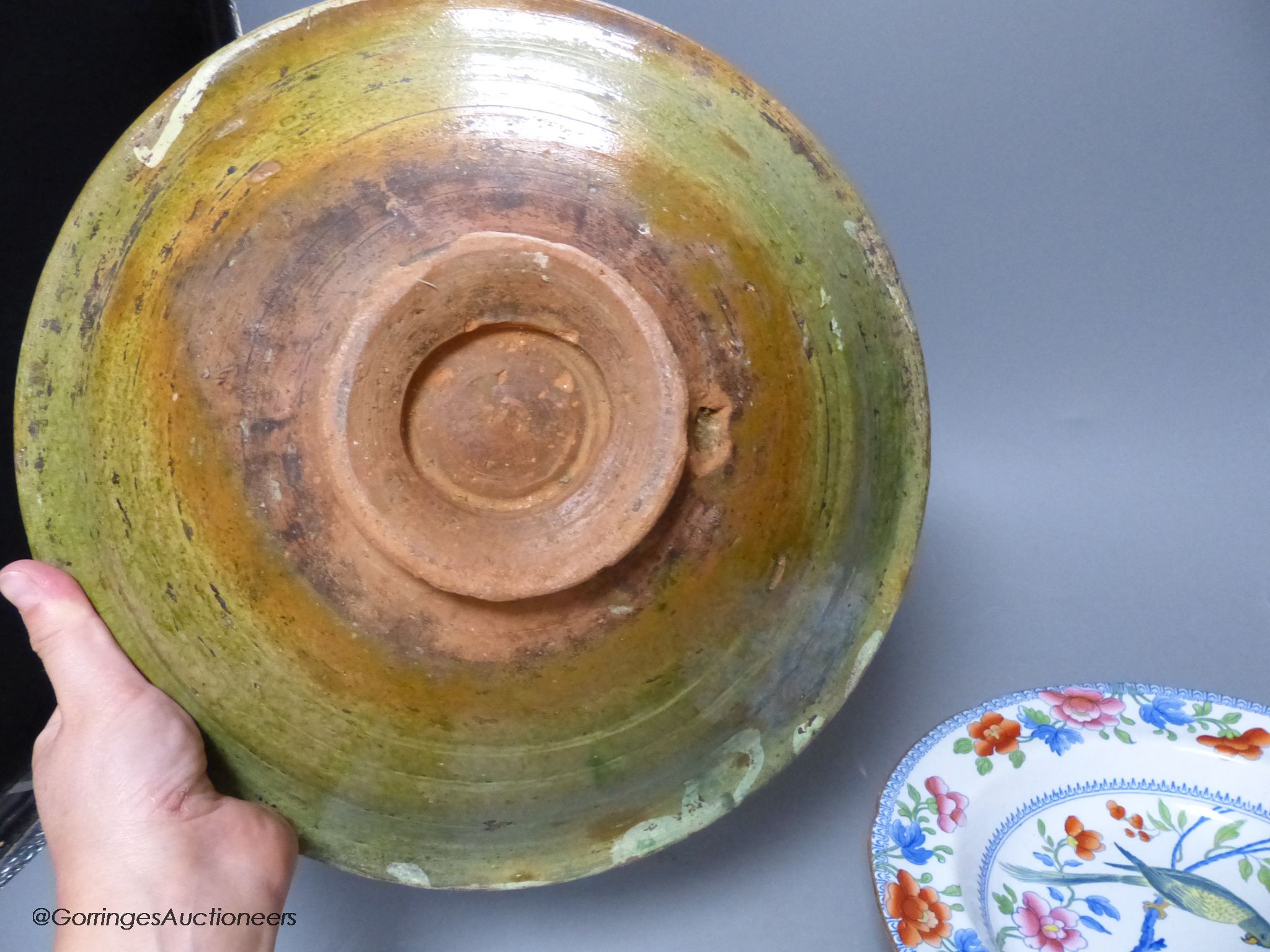 A Moroccan terracotta dish, an Ironstone dish, a green and white leaf dish, largest 30cm
